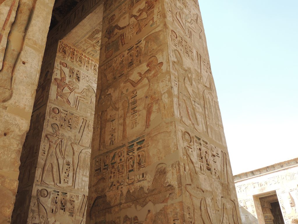 Ancient Egyptian carved pillar with colored relief scenes inside Kom Ombo Temple Egypt
