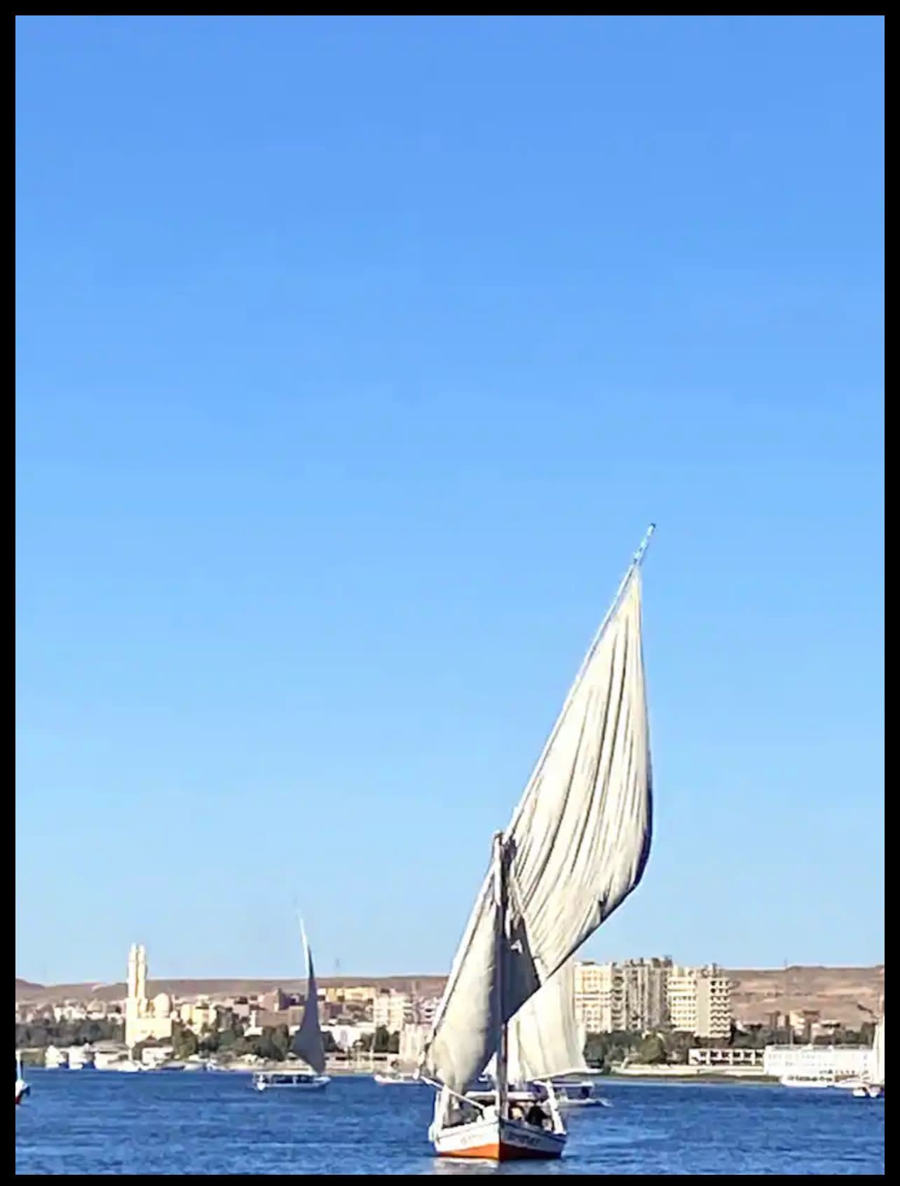 traditional felucca sailing on the Nile in Aswan slow travel Egypt experience