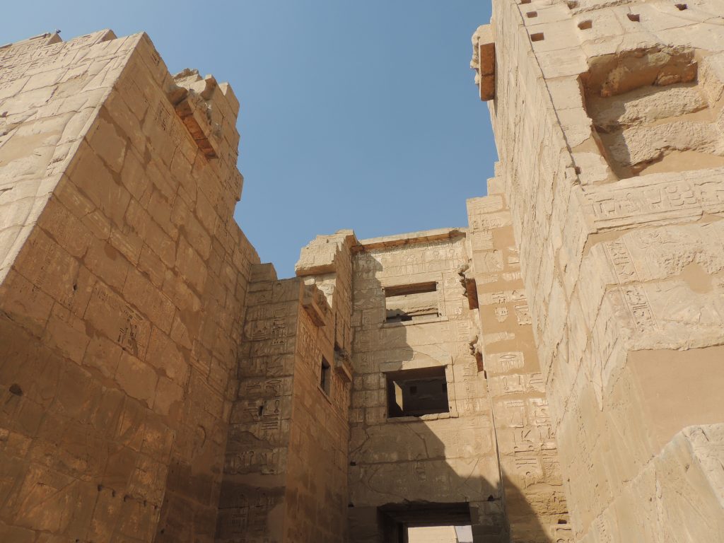 Stone gateway and hieroglyph-covered walls inside Karnak Temple complex in Luxor, Egypt