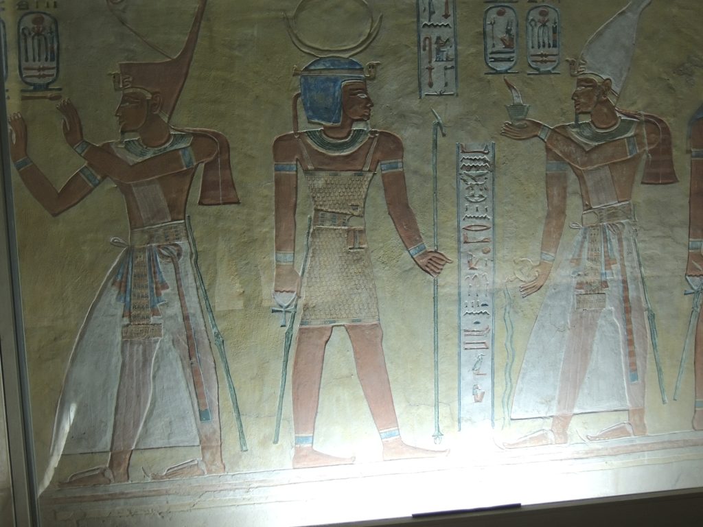 Ancient Egyptian wall painting showing three standing deities inside the tomb of Prince Amen Khepshef (QV55), Valley of the Queens, Luxor
