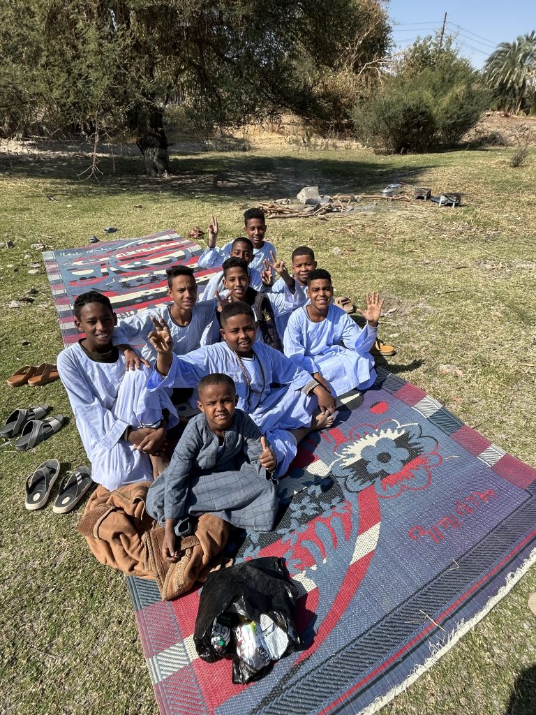 Children enjoying a day by the Nile in Upper Egypt during a felucca travel experience